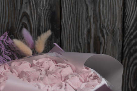Marshmallow bouquet packed in craft paper. Zephyr rose flowers.の写真素材