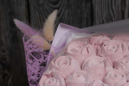 Marshmallow bouquet packed in craft paper. Zephyr rose flowers.の写真素材