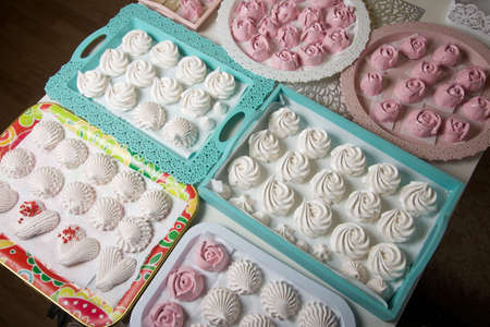 Homemade marshmallows of various shapes and colors are laid out on trays. Stabilization of Zephyr before packaging.の写真素材