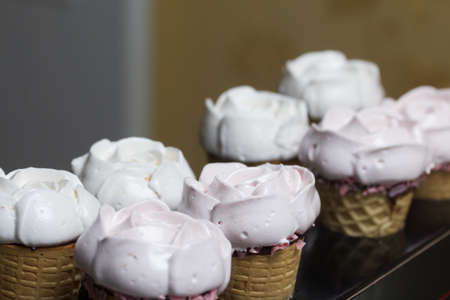 Homemade marshmallows. Marshmallow in a waffle cone on a counter for making. Made in the shape of a rose. Close-up shot.の写真素材