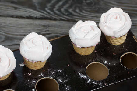 Homemade marshmallows. Marshmallow in a waffle cone on a counter for making. Made in the shape of a rose. Close-up shot.の写真素材