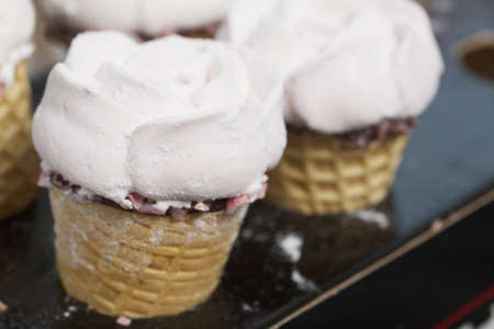 Homemade marshmallows. Marshmallow in a waffle cone on a counter for making. Made in the shape of a rose. Close-up shot.の写真素材