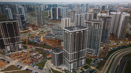 Construction of modern multi-storey buildings. Construction of a new city block. Buildings under...