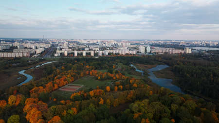Flight over the autumn park. Trees with yellow autumn leaves are visible. On the horizon there is a...