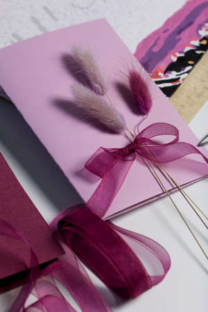 Making greeting cards. Paper blanks, ribbons and lagurus branches. Are laid out on the table...