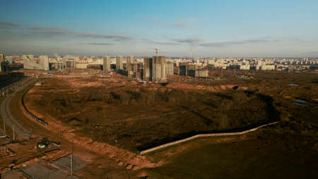 Construction site. Construction of modern multi-storey buildings. The work of construction cranes is visible. Against the background of the blue sky. Aerial photography.の写真素材