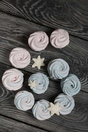 Marshmallow blue and pink. Decorated with mastic snowflakes. On black pine boards.の写真素材