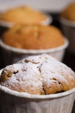 Freshly baked muffins with chocolate and raisins. Spread out on a baking sheet. Some are sprinkled...