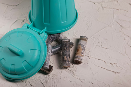Corroded waste batteries. Finger-type batteries and accumulators for disposal. They lie in a trash can. Recycling of hazardous waste.の写真素材