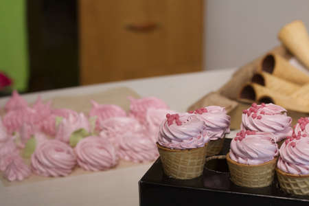 Pink marshmallow in waffle cones. Packed in sachets. close-up.