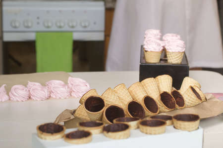 Pink marshmallow in waffle cones. Packed in sachets. close-up.