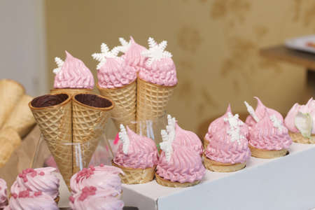 Pink marshmallow in waffle cones. Packed in sachets. close-up.
