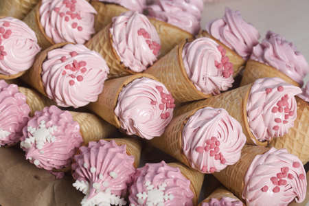 Pink marshmallow in waffle cones. Packed in sachets. close-up.