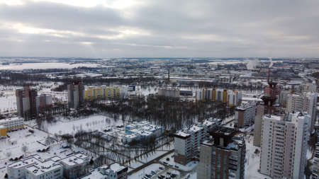 Construction site of a modern city block. High rise buildings under construction. construction tower cranes. Construction site in winter. Aerial photography at sunset.の写真素材