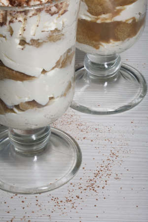 Dessert with Savoiardi cookies and cream. Tiramisu cookies. close-up.