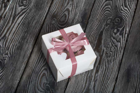 Roses, tulips and chrysanthemums from marshmallows. Zephyr flowers. In craft packaging. Tied with ribbon.の写真素材