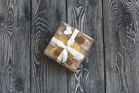 Homemade eclairs with cream. They lie on a plate. Custard pastries with cream. In a gift box....