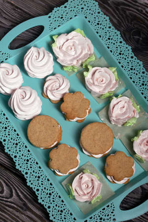 Homemade marshmallows and marshmallow sandwiches. Zephyr in the form of roses with green leaves....