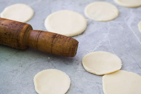 Preparing the dough for dumplings with blueberries.