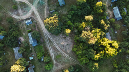 Rural landscape at sunset. Roofs of houses are visible among the trees. aerial photography.の写真素材