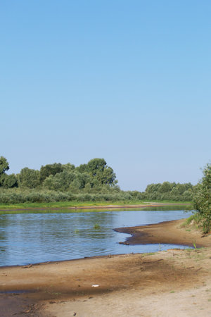 river flows. Both banks are visible with vegetation. The Pripyat River in southern Belarus.