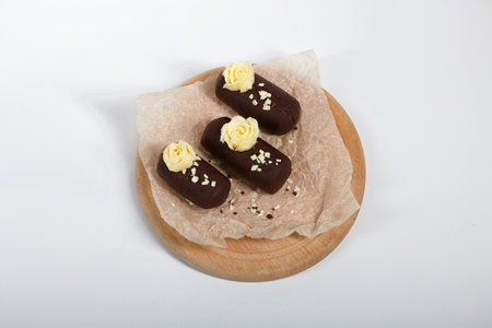 Cake potato. Decorated with butter cream. On a white background. Shot close-up.