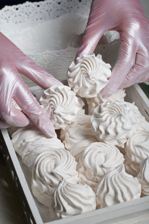 homemade zephyr. Homemade marshmallows. A woman puts a ready-made zephyr on a tray.の写真素材