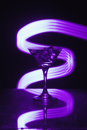 Martini glass with ice. On the bar. Against the background of neon light.の写真素材