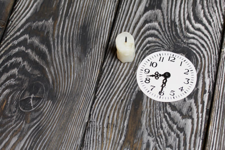 Candle stub and dial with arrows at 20:30. Global ecology, International Day of Energy Saving or...