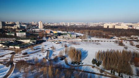 A winding bike path in a city park. City park in winter. Snow lies on the ground. aerial photography.の写真素材