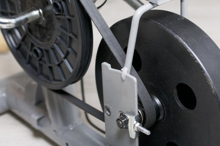 Elements of an exercise bike. Servicing the drive pulley and flywheel. close-up.