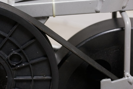 Elements of an exercise bike. Servicing the drive pulley and flywheel. close-up.