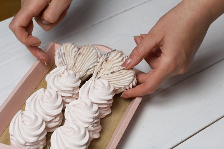 A woman adjusts zephyr on trays. Homemade marshmallow. close-up.の写真素材