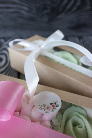 Two boxes with marshmallows. Zephyr flowers. Homemade marshmallows in a paper gift box. The box is tied with a ribbon tied into a bow. Label for the text. Close-up.の写真素材