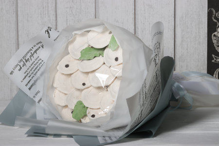 Bouquet of marshmallows on a white wooden background. Dumplings made of marshmallows.の写真素材