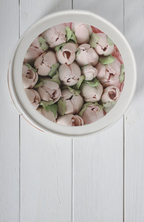 Marshmallows in a hatbox with a transparent lid. Tulips made of marshmallows. Homemade marshmallows. taken from above.の写真素材