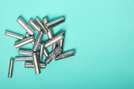 Used finger batteries on a light green background. Field for text.
