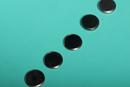 Used batteries on a light green background.