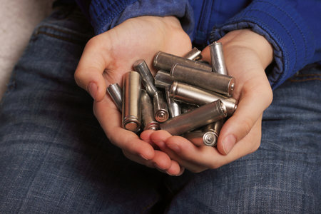 Wasmed finger batteries in the palms of a teenager close -up, waste processing and ecology