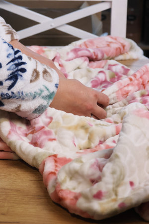 A woman reviews a warm robe. Close-up. Oblique Angle.