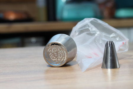 Set of pastry tips made from stainless steel. Plastic pastry bag included. Eye-level Shotの写真素材