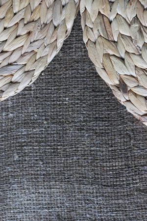 Two placemats made of water hyacinth on rough linen burlap.