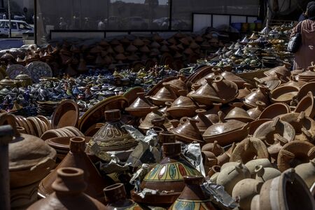 Dozens of tagine clay pots for sale in outdoor souk in Moroccoの写真素材