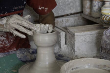 Close-up motion of hands making large ceramic vaseの写真素材