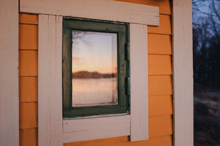 yellow wooden cabin in a sunset lightの写真素材
