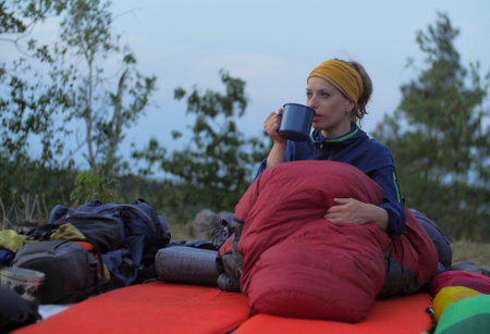 Female hiker drinking while caming