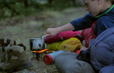 female hiker cooking outdoorsの写真素材