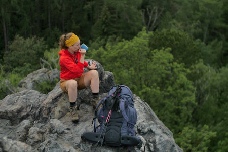 caucasian hiker standing on a rocky peak