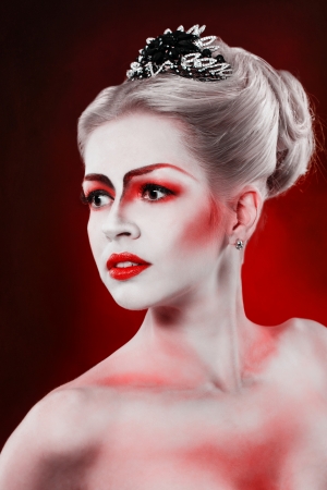 Portrait of attractive girl with theatrical make-up, tiara and hairdoの写真素材