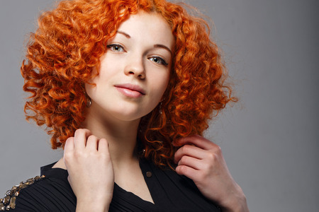 Attractive young girl with red hair in a studio portraitの写真素材